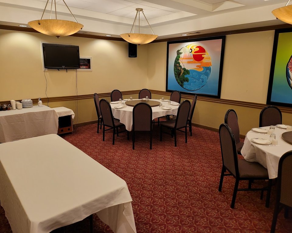 Spacious dining room with round tables.
